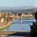 Bridges and a village with an enormous grassy field and mountains in the distance